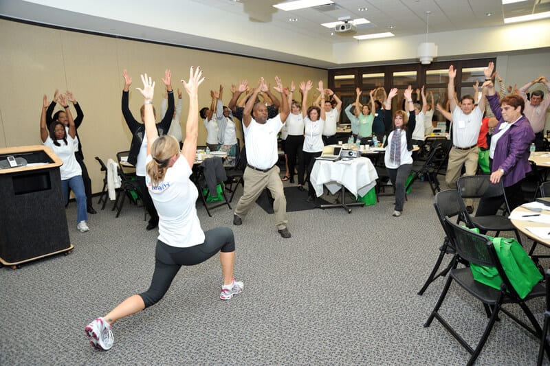 Employees participating in workplace wellness program session